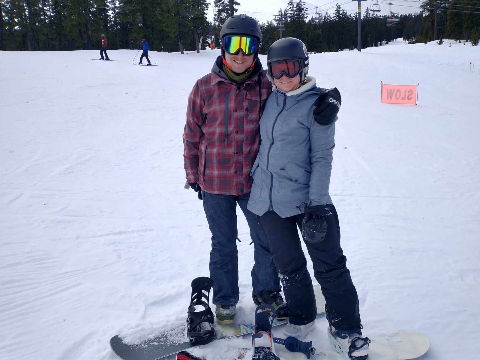 Maggie and Jack on snowboards on a snowy slope